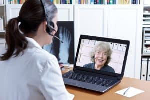 doctor cares for medicare patient via telehealth